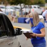 Third-grade teacher Sheri Burke hands out packets of school curriculum and materials at Greywolf Elementary School on Sept. 2, the first day of school for Sequim students. Sequim Gazette photo by Michael Dashiell