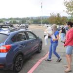 Third-grade teacher Sheri Burke, center, and reading specialist Natalie Fortier hand out packets of school curriculum and materials at Greywolf Elementary School on Sept. 2, the first day of school for Sequim students. Sequim Gazette photo by Michael Dashiell