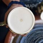 The signature for Sydney Swansons Sunshine Ceramics Studio is a small sun on the bottom of each piece.