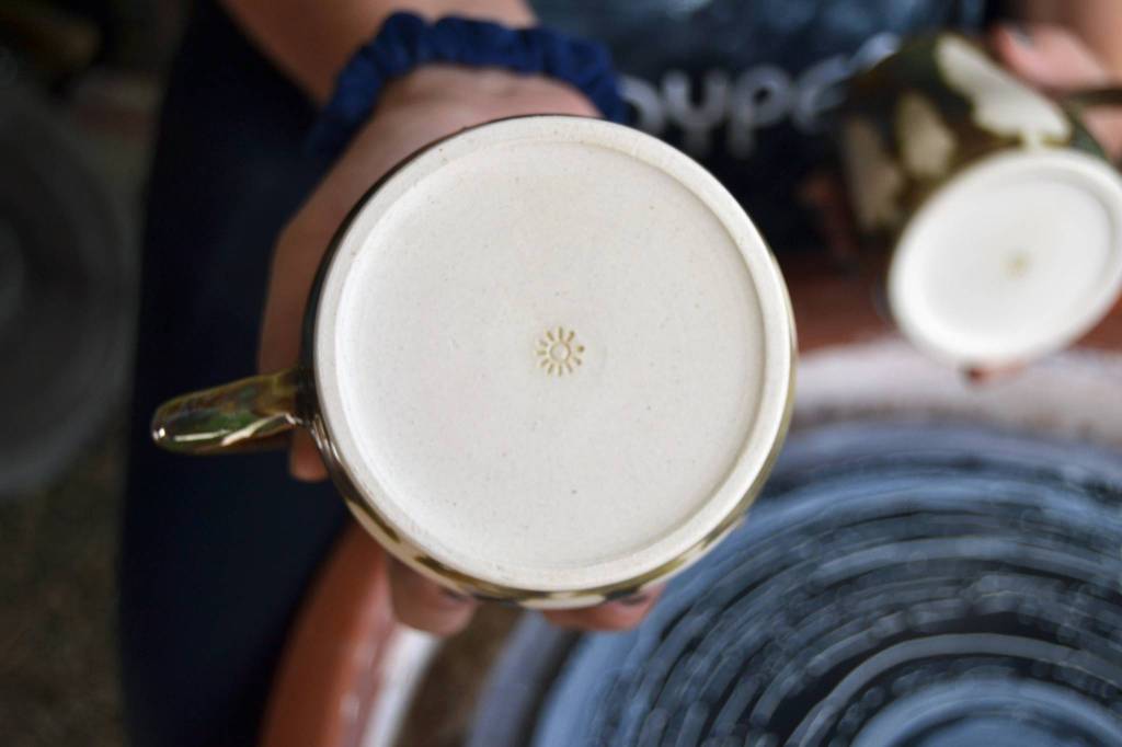 The signature for Sydney Swansons Sunshine Ceramics Studio is a small sun on the bottom of each piece.