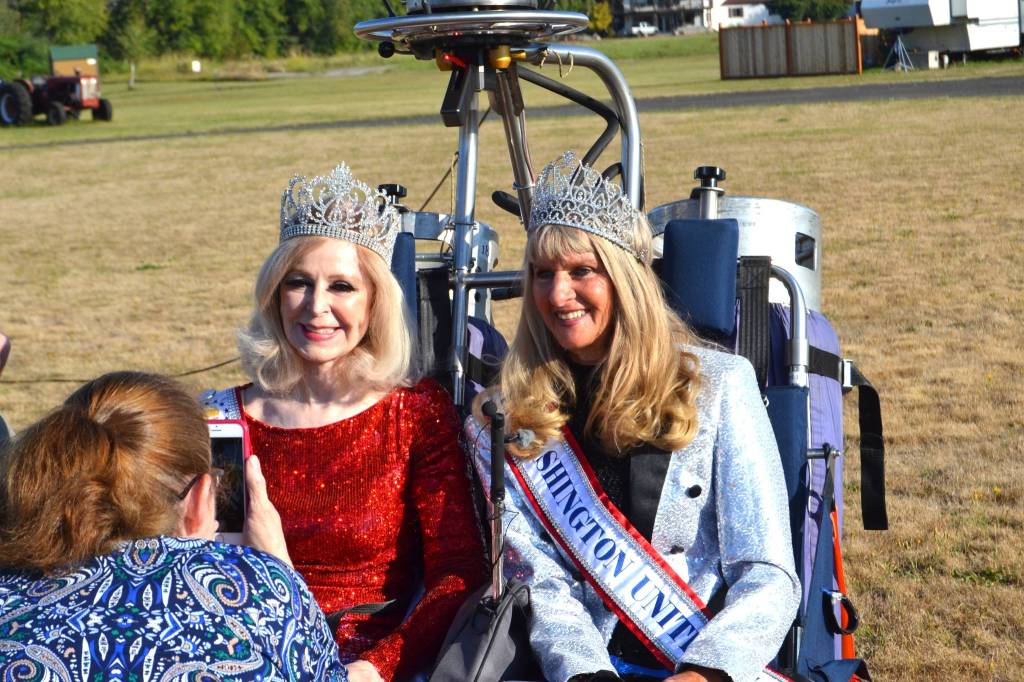 Above: Cherie Kidd, Ms. Senior USA 2019-2020, left, and Captain-Crystal Stout, Ms. Senior Washington USA, pose for a photo before they go up to shoot a promotional video for the Ms. Senior USA pageant. Right: John Gussman films Cherie Kidd, Ms. Senior USA 2019-2020, and Captain-Crystal Stout, Ms. Senior Washington USA, shoot a promotional video for the upcoming pageant in Las Vegas. Stout said she is excited for the opportunity to win because she could serve as an ambassador for Shriners Hospital for Children and offer rides to children. Sequim Gazette photos by Matthew Nash