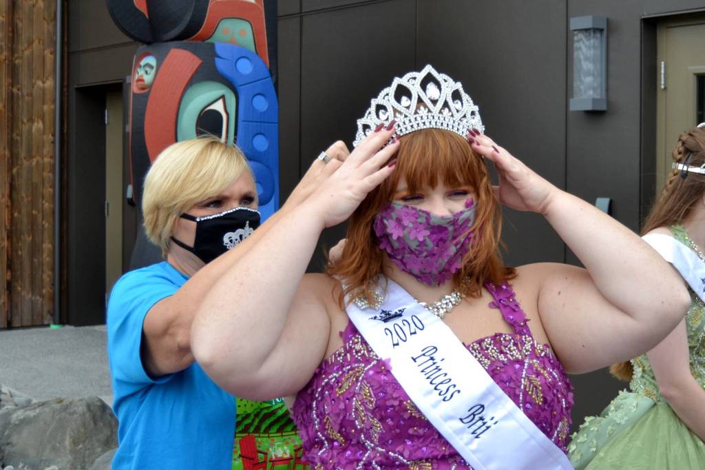 Volunteer Lynn Horton helps princess Brii Hingtgen pin her crown prior to the float reveal session on Sept. 19. Sequim Gazette photo by Matthew Nash