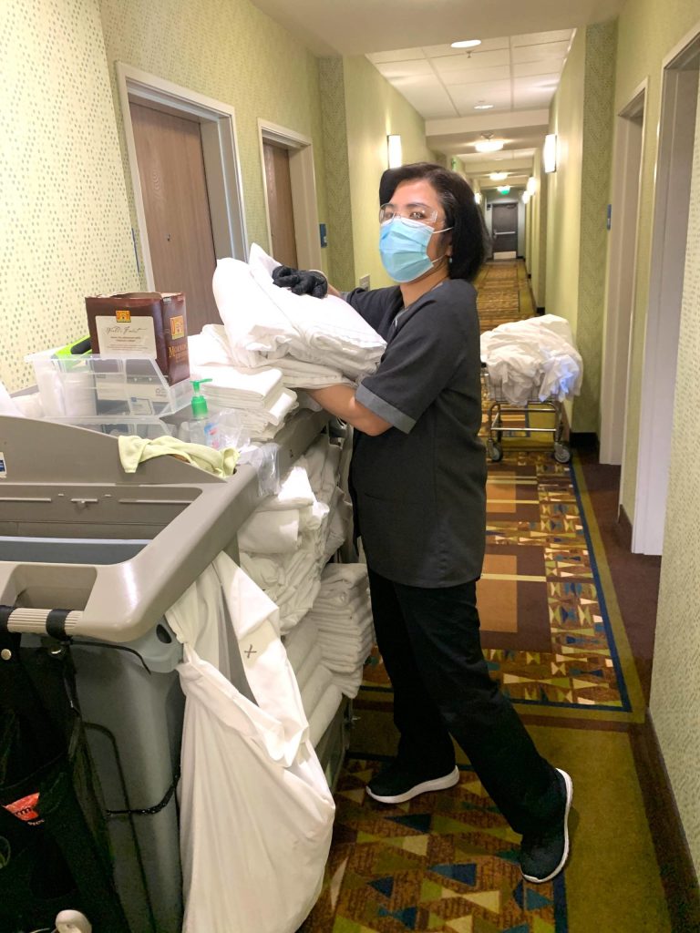 Ru Bi Boyd readies towels for rooms at the Sequim Holiday Inn Express & Suites. Less towels are being placed in rooms and even unused towels and bedding are being cleaned to prevent the spread of COVID-19, say staff. Photo courtesy of Namaste Cousins
