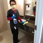 Olena Palenga sanitizes one of the many rooms in Sequim Holiday Inn Express & Suites. Staff offer housekeeping menus for visitors staying more than one night so that they can have items left at their door or brought inside at their discretion. Photo courtesy of Namaste Cousins