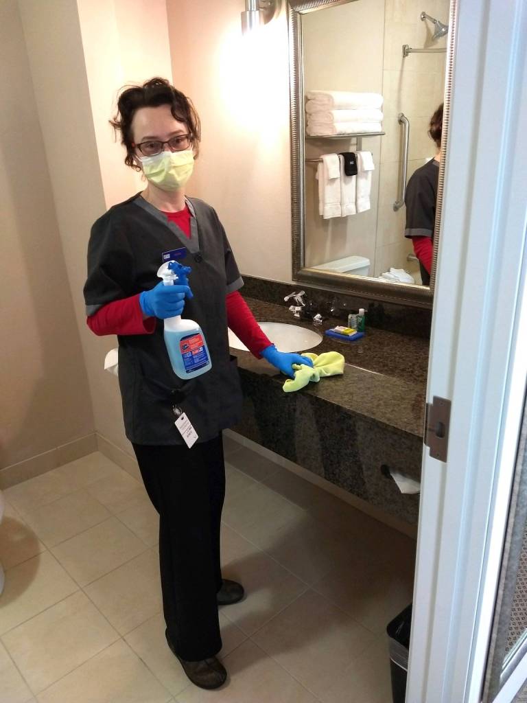 Olena Palenga sanitizes one of the many rooms in Sequim Holiday Inn Express & Suites. Staff offer housekeeping menus for visitors staying more than one night so that they can have items left at their door or brought inside at their discretion. Photo courtesy of Namaste Cousins