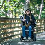Ian Mackay, executive director of Ians Ride, rides his powered wheelchair on the Olympic Discovery Trail near Port Angeles last month. Photo by Jesse Major/Ians Ride