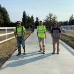 Brothers Daniel, left, and Sam, right, stand with their dad Rex Berneking at a concrete project they worked on together. Over the years, Rex has employed all of his sons for his Berneking Concrete Homes. Submitted photo