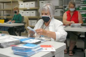 Election worker Connie Miller of Port Angeles, center, along with co-workers Nancy Mills of Port Angeles, left, and Jam Janni of Sequim, right, open ballots for the primary election at the Clallam County Courthouse in Port Angeles on Aug. 4. Ballots for the Nov. 3 general election go into the mail for Clallam County voters today, Oct. 14. File photo by Keith Thorpe/Olympic Peninsula News Group