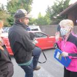 At right, Sharon Palmer, who coordinated a spay/neuter clinic for Peninsula Friends of Animals, helps a couple with their four dogs gets services at Sequim Animal Hospital on Sept. 30. Sequim Gazette photo by Michael Dashiell