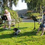 Bonnie Booth, left, and Cindy MacKay take a break from playing duets in the park near the intersection of Sequim Avenue and Washington Street in downtown Sequim on Oct. 2. Enjoying some of the tunes is Woody, a 9-month-old French Brittany Spaniel. Sequim Gazette photo by Michael Dashiell