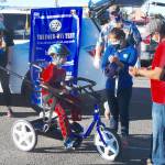 Rodney Torres smiles after riding his new bike, as his parents Mayra and Teles cheer him on. Photo by Doug Schwarz