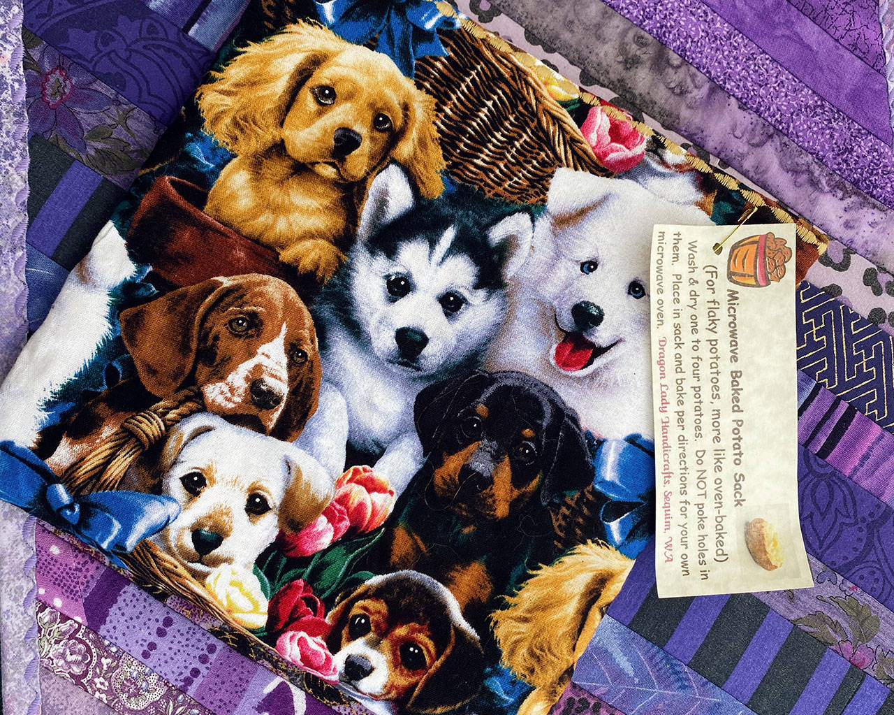 Check out DragonLady Handicrafts offers microwave baked potato sacks with pet-themed prints (above) and Old World Salves Old World Tail Saver (right), is a first aid tool for animal lovers, at the Sequim Farmers & Artisans Market. Photos by Emma Jane Garcia