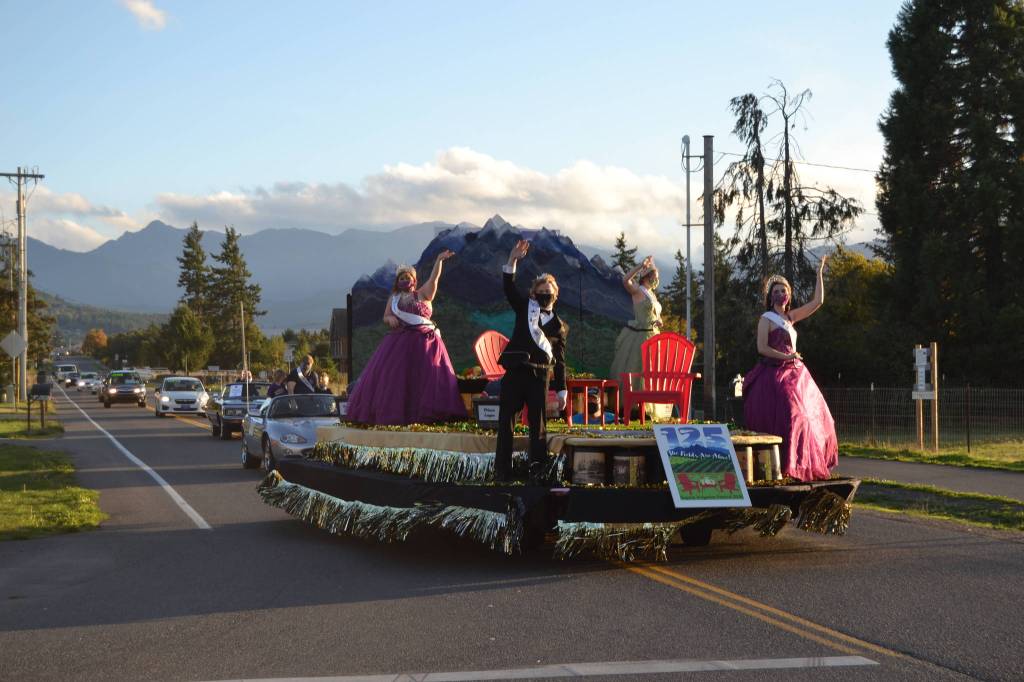 The Sequim Irrigation Festival float takes the corner of North Priest Road and Hendrickson Road during its procession on Oct. 10. Sequim Gazette photo by Matthew Nash