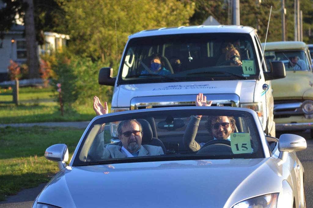 Grand Pioneer Walter Grant with Marcus Oden wave during the procession of the Sequim Irrigation Festival on Oct. 10. Sequim Gazette photo by Matthew Nash