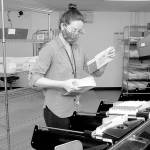 Keith Thorpe/Peninsula Daily NewsClallam County election worker Nicole Mischke pulls sorted ballots from a sorting machine on Wednesday at the county courthouse in Port Angeles. County Auditor Shoona Riggs said Wednesday that they have received about 20,000 ballots out of almost 57,000 sent to registered voters.