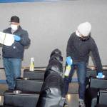 José Martinez, general manager of Deer Park Cinema, left, and maintenance worker Megan Cook wipe down seats in the Port Angeles theater complex Thursday, Oct. 22. Photo by Keith Thorpe/Olympic Peninsula News Group