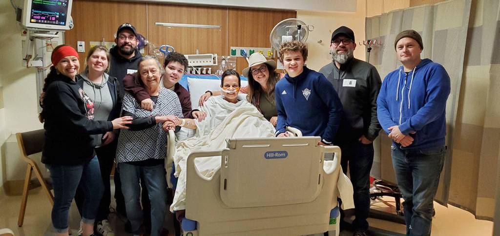 Family members join Melissa Smith of Sequim, center, in the intensive care unit at the University of Washington in February — just before the COVID-19 outbreak that shut down medical centers across the state. Submitted photo