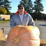 Ross Osborn brought his giant pumpkin to JACE Real Estate Company to share with people for Halloween. Visitors can guess its weight and/or post selfies to JACEs social media page for a chance to win local gift certificates. Sequim Gazette photo by Matthew Nash