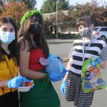 From left, Sequim High School students Alliyah Weber, Christina Caples and Delaney Nucci hand out candy at SHSs drive-thru Halloween event on Oct. 31. Sequim Gazette photo by Michael Dashiell