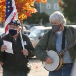 Tim Wheeler, left, and a group of about 40 individuals sing Woody Guthries This Land Is Your Land, accompanied by Steve Koehler on banjo, at the Sequim Civic Center on Nov. 4. The pair joined an event organized in part by Indivisible Sequim and part of a nation-wide rally to protect the results of the 2020 general election in case President Donald Trump refuses to concede. This is America; all our votes must count and be counted, said Elizabeth Schilling, event co-organizer. Sequim Gazette photo by Michael Dashiell