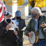 Tim Wheeler, left, and a group of about 40 individuals sing Woody Guthries This Land Is Your Land, accompanied by Steve Koehler on banjo, at the Sequim Civic Center on Nov. 4. Sequim Gazette photo by Michael Dashiell