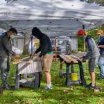 Scouts and other volunteers help complete refurbishing of six picnic tables at Pioneer Memorial Park, part of Calem Ryne Klinger’s Eagle Scout project. Photo courtesy of Sequim Prairie Garden Club