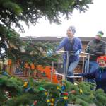 Captain-Crystal Stout, Emily Westcott and Terry Marsh add some seasonal flair to the Christmas/holiday tree at Centennial Place in downtown Sequim last week. Sequim Gazette photo by Michael Dashiell