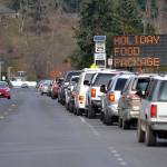 Vehicles lined up throughout the three-hour span on Nov. 20 to receive free Thanksgiving meals from the Family Holiday Meal Bag distribution program in Carrie Blake Community Park. Sequim Gazette photo by Matthew Nash