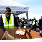 Calvin Barnard, senior vice commander of Carlsborg VFW Post 6787, places a pie in a bag for a family at the Family Holiday Meal Bay program on Nov. 20. Sequim Gazette photo by Matthew Nash