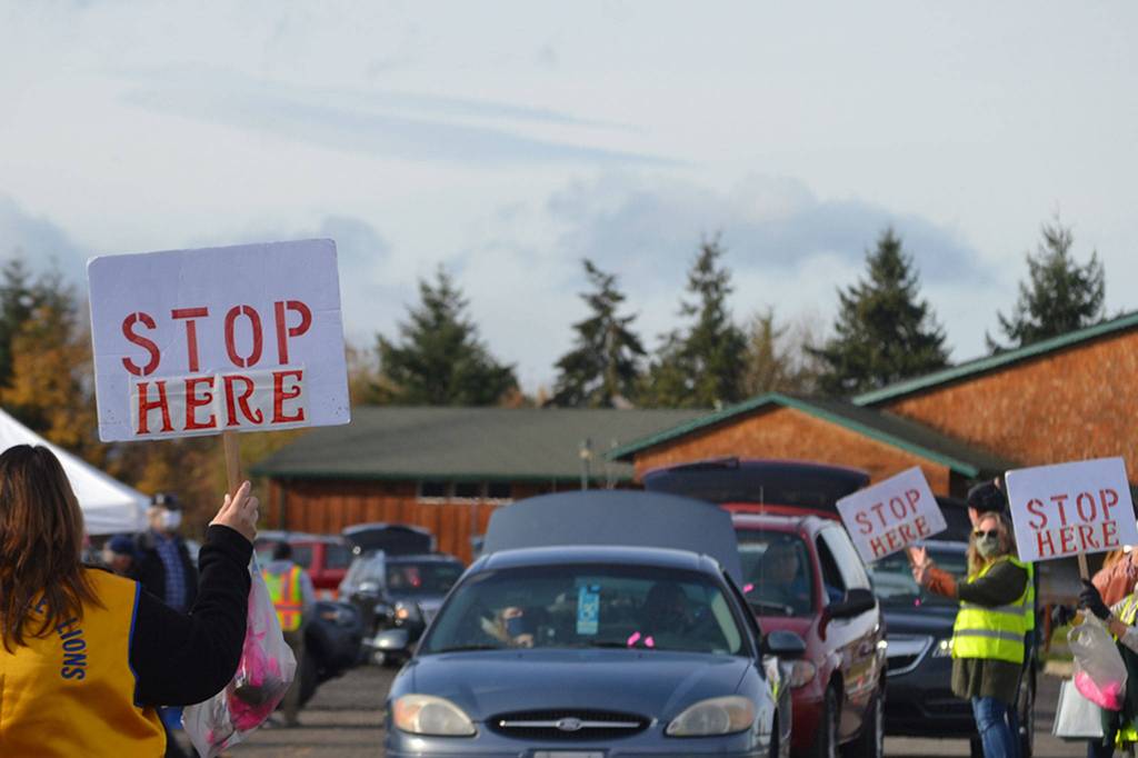 Vehicles lined up from the Albert Haller Playfields to Washington Street to receive food from the Family Holiday Meal distribution program. Sequim Gazette photo by Matthew Nash