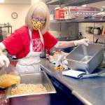 Volunteer Phyllis Meyer of Sequim adds broth to make stuffing for a traditional Thanksgiving Eve lunch at the Port Angeles Salvation Army on Nov 25. Photo by Keith Thorpe/Olympic Peninsula News Group