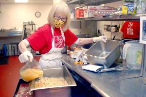 Volunteer Phyllis Meyer of Sequim adds broth to make stuffing for a traditional Thanksgiving Eve lunch at the Port Angeles Salvation Army on Nov 25. Photo by Keith Thorpe/Olympic Peninsula News Group