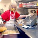 Volunteer Phyllis Meyer of Sequim adds broth to make stuffing for a traditional Thanksgiving Eve lunch at the Port Angeles Salvation Army on Nov 25. Photo by Keith Thorpe/Olympic Peninsula News Group