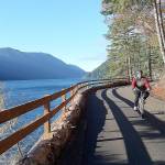 Bicyclists and hikers enjoy beautiful weather at the new Spruce Railroad Trail on Dec. 2 on the north shore of Crescent Lake. Here a cyclist rides the trail just west of the Daley Rankin Tunnel. Photo by Pierre LaBossiere/Olympic Peninsula News Group