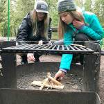 Prior to the COVID outbreak, Jenna Mason and Grace Kathol of Troop 1498 work on building a fire during a camping outing. Photo courtesy of Peter Craig