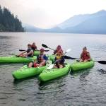 Scouting BSA Troop 1498 members enjoy a day kayaking on Lake Crescent. Below: Joshua Loucks, Joseph Henninger and Donovan Rynearson of Troop 1498 enjoy a hike at the Tubal Cain Trail earlier this year. Photos courtesy of Peter Craig