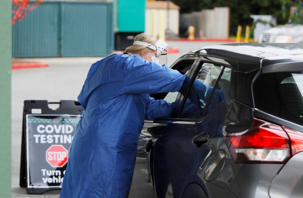 Licensed practical nurse Kelsey Trester administers a COVID-19 test at the Jamestown Family Health Clinics drive-up testing site on Dec. 7. Sequim Gazette photo by Michael Dashiell