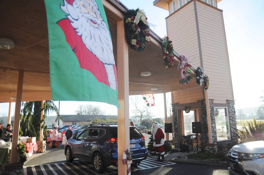 Santa Claus and his volunteer helpers meet with families at a special drive-by event at Dungeness Valley Lutheran Church on Dec. 5. Sequim Gazette photo by Michael Dashiell
