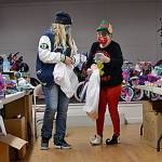 Above: Loretta Amore checks her list for her four children with elf helper Sandra Granum at Toys for Sequim Kids on Dec. 9. Below: Alma Najera looks at blankets during Toys for Sequim Kids for her three children with help from volunteer Brii Hingtgen.