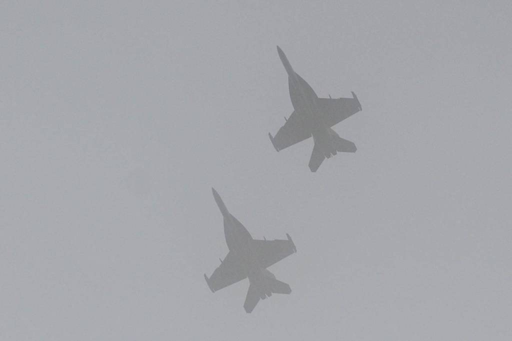 Two U.S. Navy Growler jets from NAS Whidbey Island soar above Sequim View Cemetery Saturday. Sequim Gazette photo by Michael Dashiell