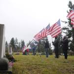 Members of the Clallam County Legion Riders Post 29 create a flag line as a patriotic backdrop to the Wreaths Across America event held. Dec. 19 at Sequim View Cemetery. Sequim Gazette photo by Michael Dashiell