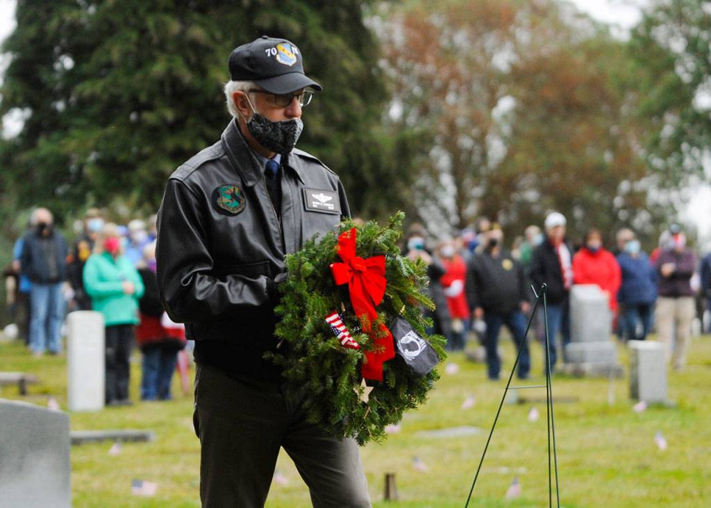 At Saturdays Wreaths Across America event at Sequim View Cemetery, Col. Randy Roberts (U.S. Air Force, ret.) prepares to lay a ceremonial wreath for U.S. military prisoners of war and missing in action. Sequim Gazette photo by Michael Dashiell