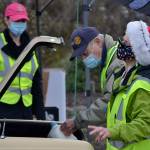 Volunteers Gretha Davis, front left, and Jim Jones, treasurer for the Sequim Noon Rotary, help load a vehicle on Dec. 18 at Carrie Blake Community Park for a Christmas-time drive-thru for food. For the day, more than 800 families received food for Christmas week. Sequim Gazette photo by Matthew Nash