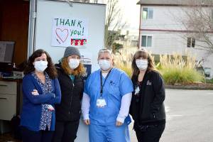 Working the COVID vaccination drive-up station Thursday are, from left, Jefferson Healthcare staffers Jaimie Hoobler, Brandy Boyd, Jess Cigalotti and Lori Banks. Diane Urbani de la Paz/Peninsula Daily News