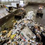 Front loaders push trash forward into one of the compactors at the Airport Road Recycling & Transfer Station on Nov. 24 in Everett. Photo by Olivia Vanni/The Herald (Everett)