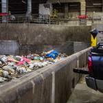 People throw their trash onto the tipping floor to be loaded into a compactor at the Airport Road Recycling & Transfer Station on Nov. 24 in Everett. Photo by Olivia Vanni/The Herald (Everett)