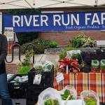 Sallie Constant of River Run Farm displays some early spring produce at the Sequim Farmers & Artisans Market. Photo by Emma Jane Garcia