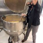 Bobi Beery, part of the gleaning team in Jefferson County, works with a fraction of the apple yield from last fall. She and fellow volunteers turned ugly apples into sauce for Port Townsend school meals. photo by Mary Hunt