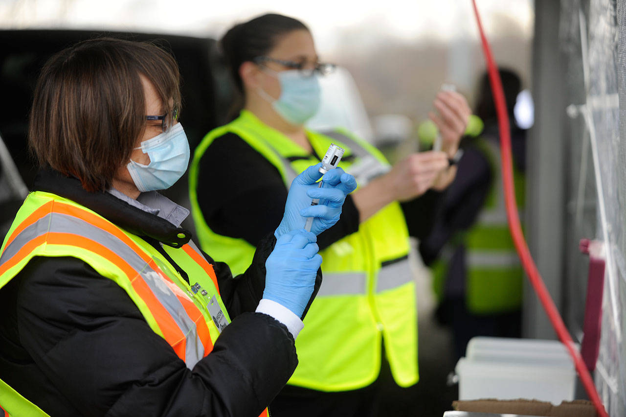 Lesli Mays, left, and Donna Short prepare COVID-19 vaccination shots at the Jamestown SKlallam Tribes clinic on Jan. 14. Sequim Gazette photo by Michael Dashiell