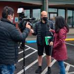 CNN photojournalist Taka Yokoyama and Kyung Lah, senior national correspondent, interview Sequim mayor William Armacost after a Coffee with the Mayor session Thursday morning in downtown Sequim. The reporters are in town through Friday talking with him and locals about QAnon. CNNs segment was tentatively scheduled to air on Friday night. Sequim Gazette photo by Matthew Nash